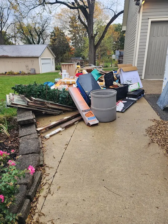 Dumpster being loaded with debris for Estate Cleanout Dumpster Rental in Valley Park